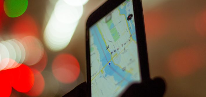 person holding smartphone displaying GPS